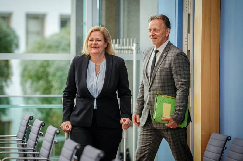 Nancy Faeser (L), Germany's Interior Minister, walks with Holger Muench, President of the Federal Criminal Police Office (BKA), to the press conference on the case figures for politically motivated crime (PMK). Kay Nietfeld/dpa