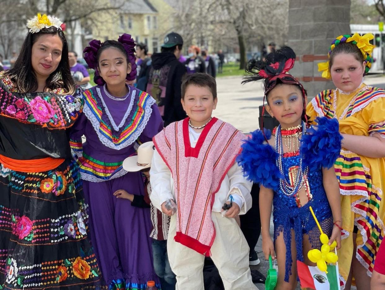 A group of young performers in traditional outfits preparing to participate in 2023 De Mayo Parade.