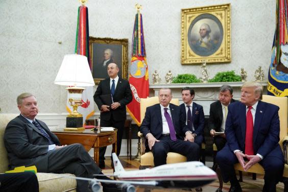 South Carolina Republican senator Lindsey Graham, left, with Turkish president Recep Tayyip Erdogan, centre, and US president Donald Trump, right, in the Oval Office on 13 November, 2019 (AFP via Getty Images)