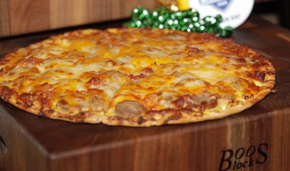 Tailgater Specialty Pizza, a Brew Pub Lottza Mozza pizza topped with bacon, brats, caramelized onions and mustard cheese sauce, is one of the new Lambeau Field concession items available for the 2023 season.