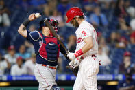 Philadelphia Phillies' Bryce Harper, right, reacts past Boston Red Sox catcher Christian Vazquez after striking out against pitcher Garrett Whitlock during the eighth inning of an interleague baseball game, Friday, May 21, 2021, in Philadelphia. (AP Photo/Matt Slocum)