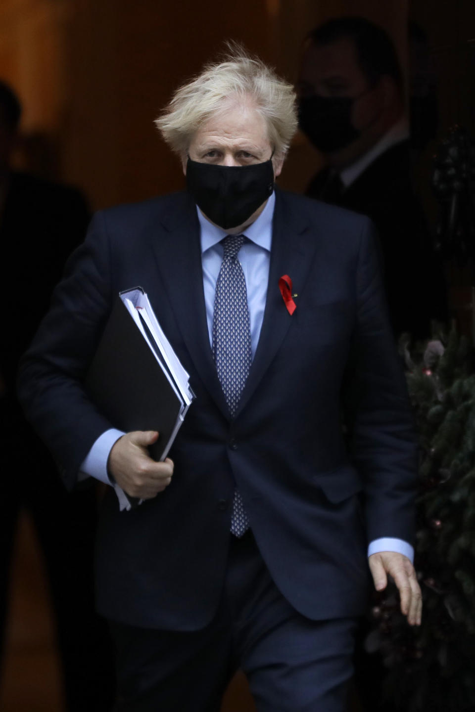 Britain's Prime Minister Boris Johnson leaves Downing Street to attend Parliament in London, Tuesday, Dec. 1, 2020. Members of Parliament will vote later Tuesday on the proposed tier system as the country prepares to come out of lockdown. (AP Photo/Kirsty Wigglesworth)