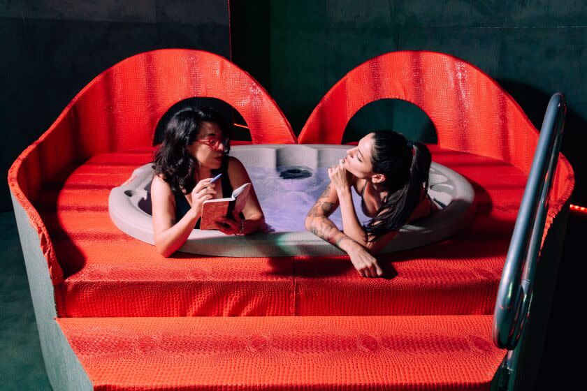 Los Angeles, Canada - September 04: Writer Christina Catherine Martinez (left) and artist Tita Cicognani sit in a hot tub in Cicognani's new installation at the UCLA Hammer Museum on Sunday, Sept. 4, 2022 in Los Angeles, California. (Wesley Lapointe / Los Angeles Times)