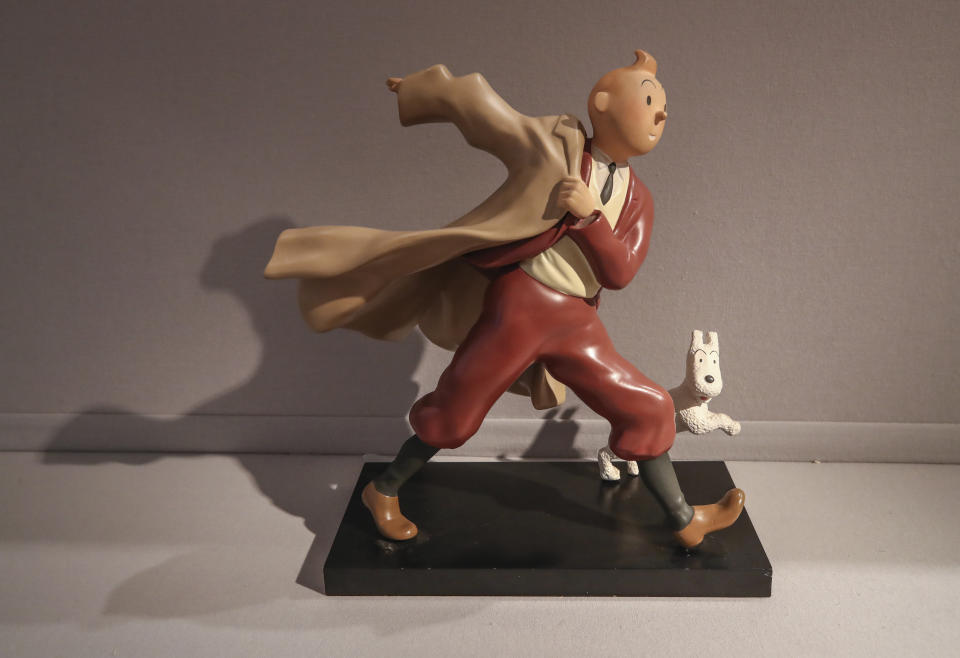 FILE - A 1988 polychrome resin sculpture of the comic character Tintin and his dog snowy from the 1941 "The Crab with the Golden Claws" album drawn by Belgian creator Herge is displayed at the Artcurial auction house in Paris, on Jan. 13, 2021. The Belgium international players taking part in the Euro soccer tournament this summer could well resemble a world-famous reporter. According to leaks on various specialized websites, the Belgium Euro 2024 away kit is a tribute to Tintin. The Belgian federation is set to unveil the new kit on Thursday March 14, 2024 during a press conference at the Hergé Museum. (AP Photo/Michel Euler, File)