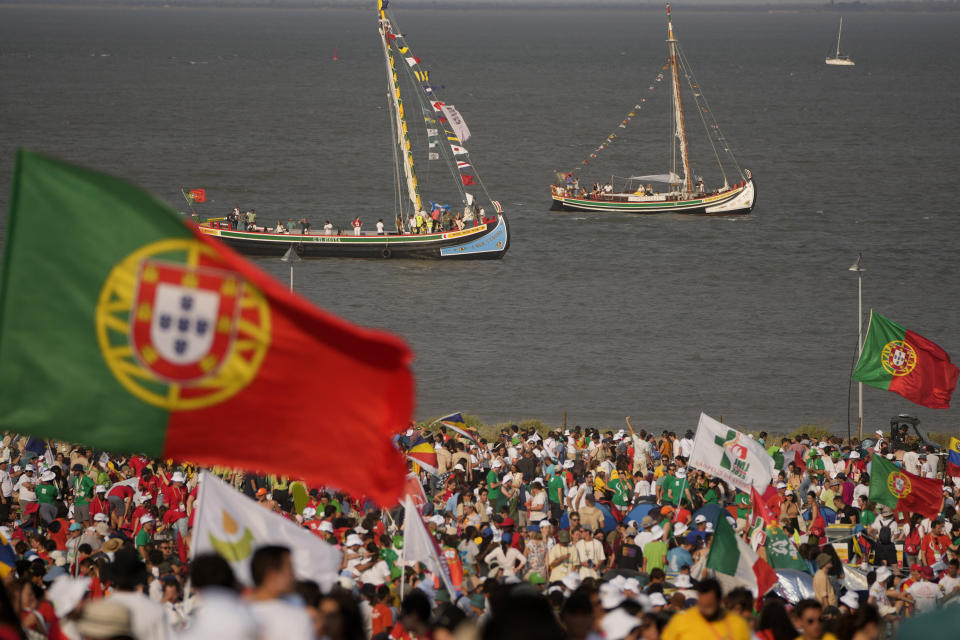 Pilgrims and faithful gather as they wait for a vigil with Pope Francis, ahead of the 37th World Youth Day, in the Parque Tejo in Lisbon, Saturday, Aug. 5, 2023. On Sunday morning, the last day of his five-day trip to Portugal, Francis is to preside over a final, outdoor Mass on World Youth Day – when temperatures in Lisbon are expected to top 40 degrees C (104F) – before returning to the Vatican. (AP Photo/Armando Franca)