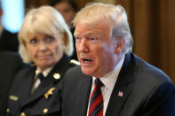 U.S. President Donald Trump speaks while Chester County, Pennsylvania Sheriff Bunny Welsh listens as the president hosts a "roundtable discussion on border security and safe communities" with state, local, and community leaders in the Cabinet Room of the White House in Washington, U.S., January 11, 2019. REUTERS/Leah Millis