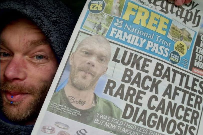 Luke Goodwin holds up a previous Grimsby Telegraph front page about his cancer fight