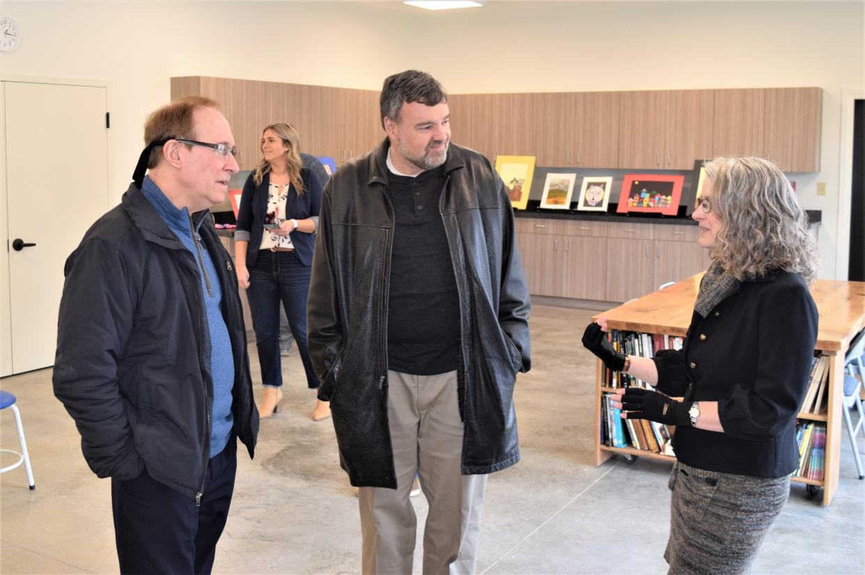 Cathie Lynch (right), one of the visual arts instructors at Holmes Center for the Art,s talks with Mark Gazdik and Steve Schneiter of Ohio Star Theater during an open house at the center, which received a grant of nearly $20,-000.