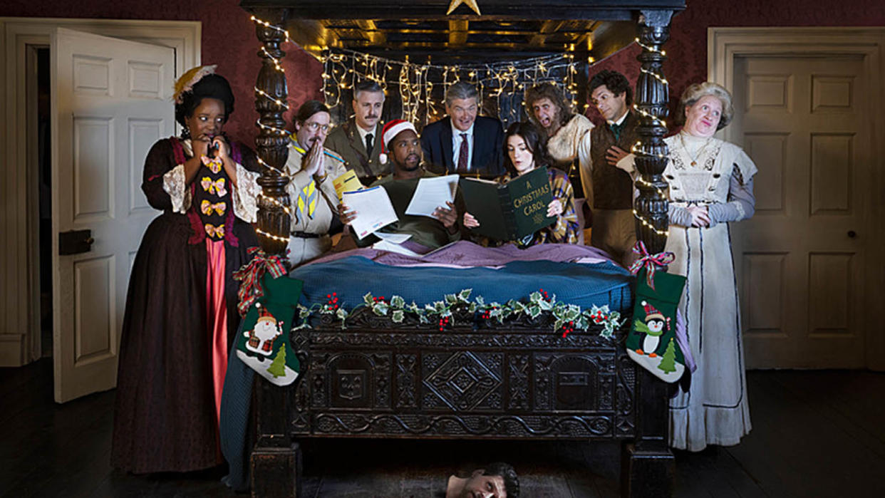  Ghosts Christmas special 2023 gather around with Mike wearing a festive hat and Alison reading A Christmas carol. 