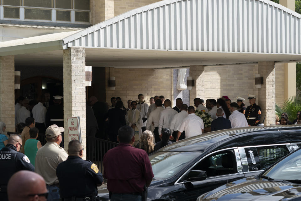 Pallbearers carry the caskets of Irma Garcia, a school teacher who was killed in last week's elementary school shooting, and her husband, Joe, into Sacred Heart Catholic Church for a funeral service in Uvalde, Texas, Wednesday, June 1, 2022. (AP Photo/Jae C. Hong)