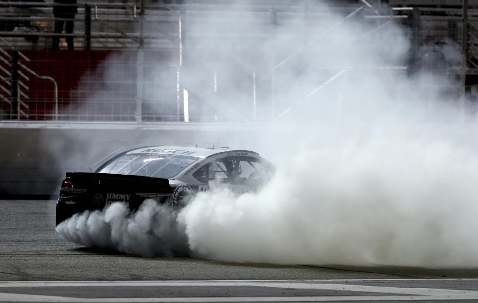 Kevin Harvick (4) does a burnout after winning a NASCAR Cup Series auto race at Atlanta Motor Speedway in Hampton, Ga., on Sunday, Feb. 25, 2018. (AP Photo/John Bazemor)