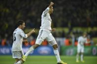 Real's Casemiro celebrates at the end of the the Champions League quarterfinal second leg soccer match between Borussia Dortmund and Real Madrid in the Signal Iduna stadium in Dortmund, Germany, Tuesday, April 8, 2014. (AP Photo/Martin Meissner)