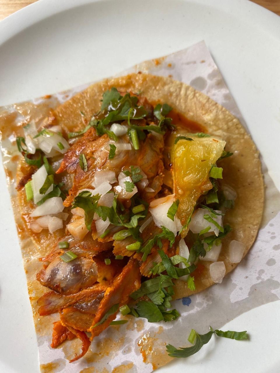 An al pastor taco on a plate.