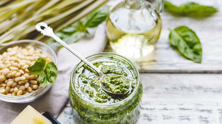 Spoon scooping fresh basil pesto