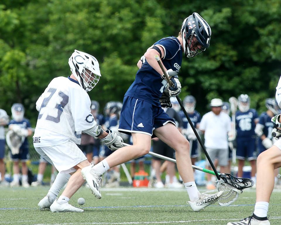 Cohasset's Josh Burke knocks the ball out of the cradle of Hamilton-Wenham's Peter Gourdeau during third quarter action of their game in the Sweet 16 round of the Division 4 state tournament at Cohasset High School on Saturday, June 11, 2022. 