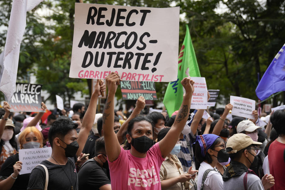 A protester holds a slogan during a rally in front of the office of the Commission on Elections as they question the results of the presidential elections in Manila, Philippines on Tuesday May 10, 2022. The namesake son of late Philippine dictator Ferdinand Marcos appeared to have been elected Philippine president by a landslide in an astonishing reversal of the 1986 "People Power" pro-democracy revolt that booted his father into global infamy. (AP Photo/Aaron Favila)