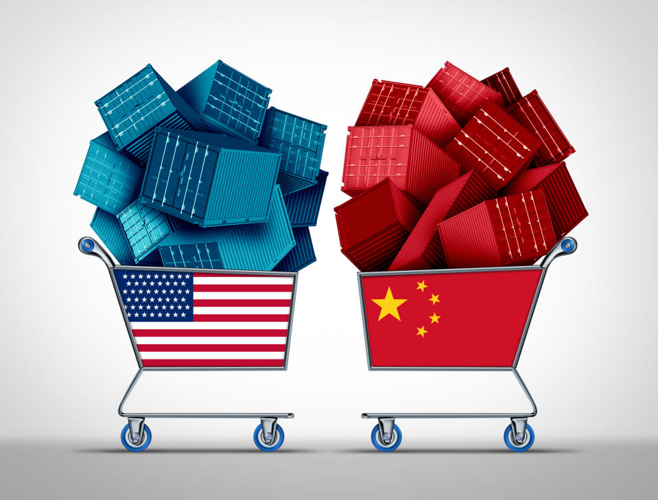 Shopping carts filled with miniature shipping containers and marked with U.S. and Chinese flags.