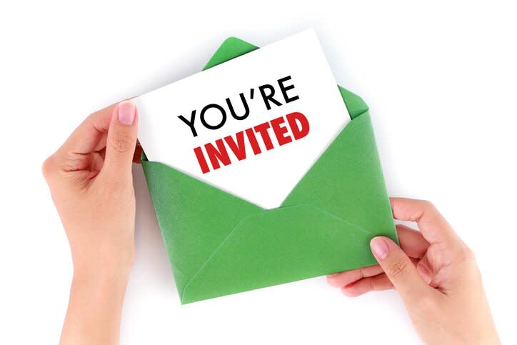 Cropped Hand Of Woman Holding Paper With Text Against White Background