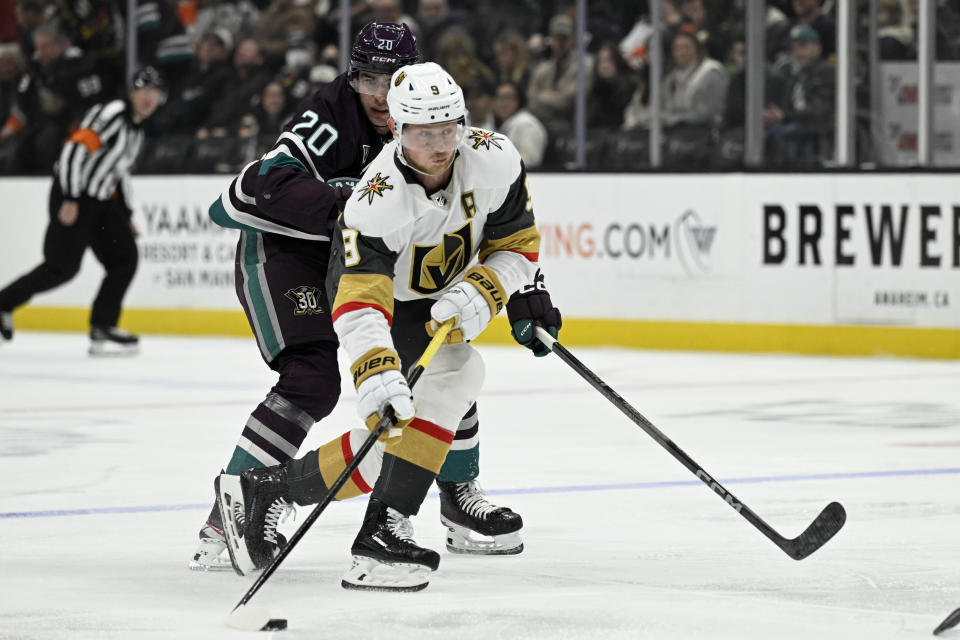 Vegas Golden Knights center Jack Eichel (9) controls the puck with pressure from Anaheim Ducks right wing Brett Leason (20) during the first period of an NHL hockey game in Anaheim, Calif., Wednesday, Dec. 27, 2023. (AP Photo/Alex Gallardo)