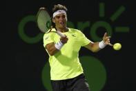 Mar 27, 2017; Miami, FL, USA; Malek Jaziri of Tunisia hits a forehand against Stan Wawrinka of Switzerland (not pictured) on day seven of the 2017 Miami Open at Crandon Park Tennis Center. Wawrinka won 6-3, 6-4. Mandatory Credit: Geoff Burke-USA TODAY Sports