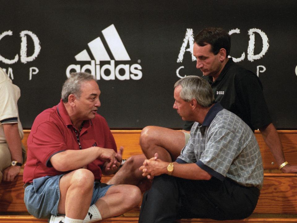 Vaccaro (red shirt) speaking in 1998 at an Adidas basketball camp with Kansas coach Roy Williams (grey short) and Duke coach Mike Krzyzewski (black shirt).