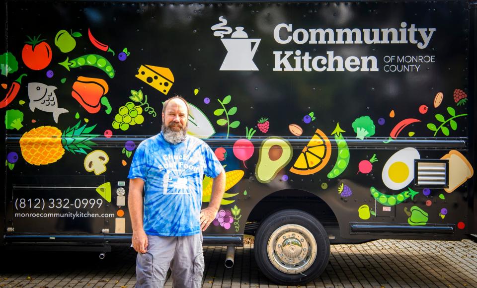Tim Clougher stands next the Community Kitchen food truck in 2021.
