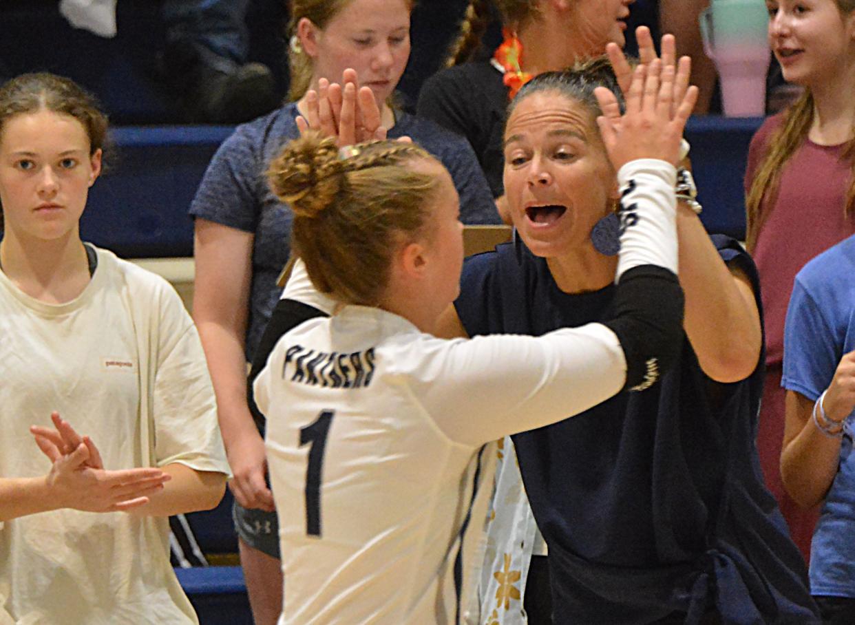 Great Plains Lutheran head coach Jacklyn Karli congratulates Kaitlyn Rawerts during a season-opening high school volleyball match against Webster Area on Tuesday, Aug. 22, 2023 in Watertown.