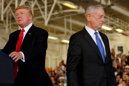 FILE PHOTO: U.S. President Donald Trump (L) is introduced by Defense Secretary James Mattis (R) during the commissioning ceremony of the aircraft carrier USS Gerald R. Ford at Naval Station Norfolk in Norfolk, Virginia, U.S. on July 22, 2017. REUTERS/Jonathan Ernst/File Photo