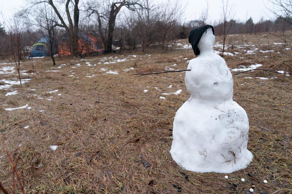 A snowman melts away in the rain Thursday. It was created by a resident of a homeless camp just south of Walmart, 1301 S.W. 37th.