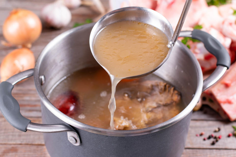 A ladle resting over some stock.