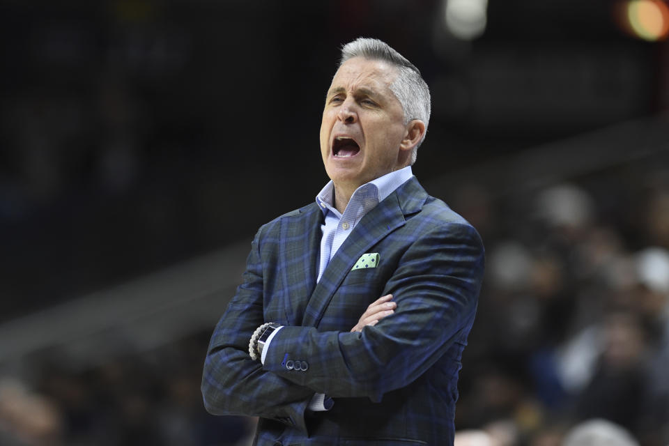 South Florida' head coach Brian Gregory shouts instructions to his team during the first half of an NCAA college basketball game against Connecticut, Sunday, Feb. 23, 2020, in Storrs, Conn. (AP Photo/Stephen Dunn)