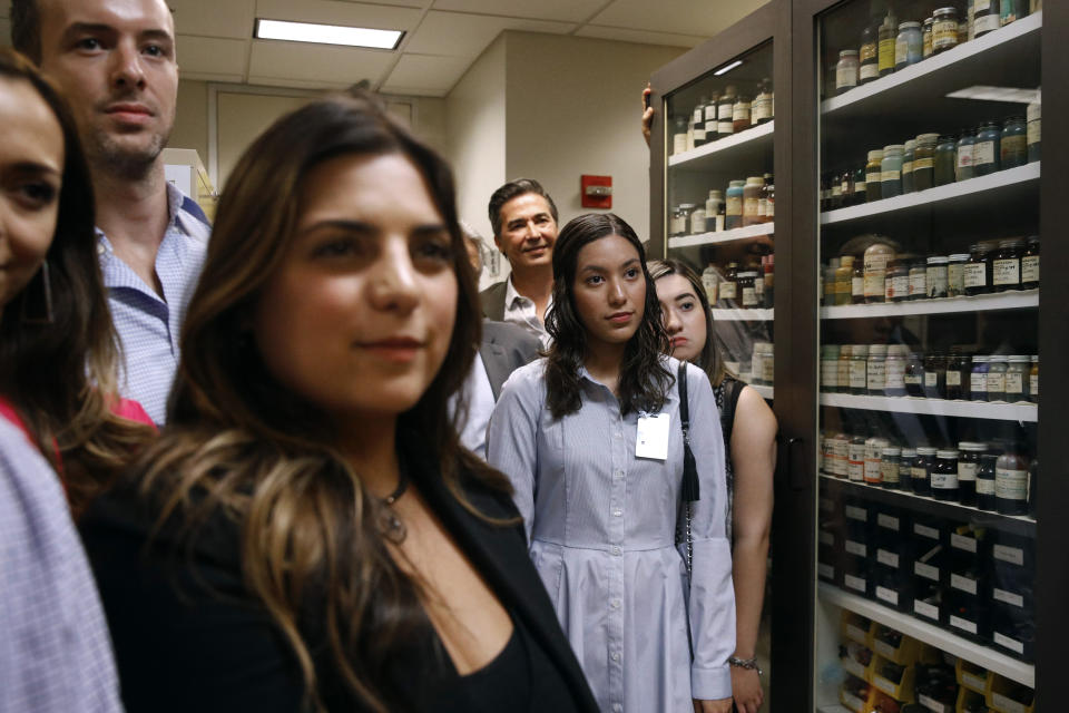 In this June 27, 2019 photo, family members of former U.S. Secret Service chief chemist Antonio Cantu tour an International Ink Library that was named in remembrance of Cantu at the Secret Service headquarters building in Washington. The library contains more than 15,000 samples of pen, marker and printer inks dating back to the 1920s. (AP Photo/Patrick Semansky)