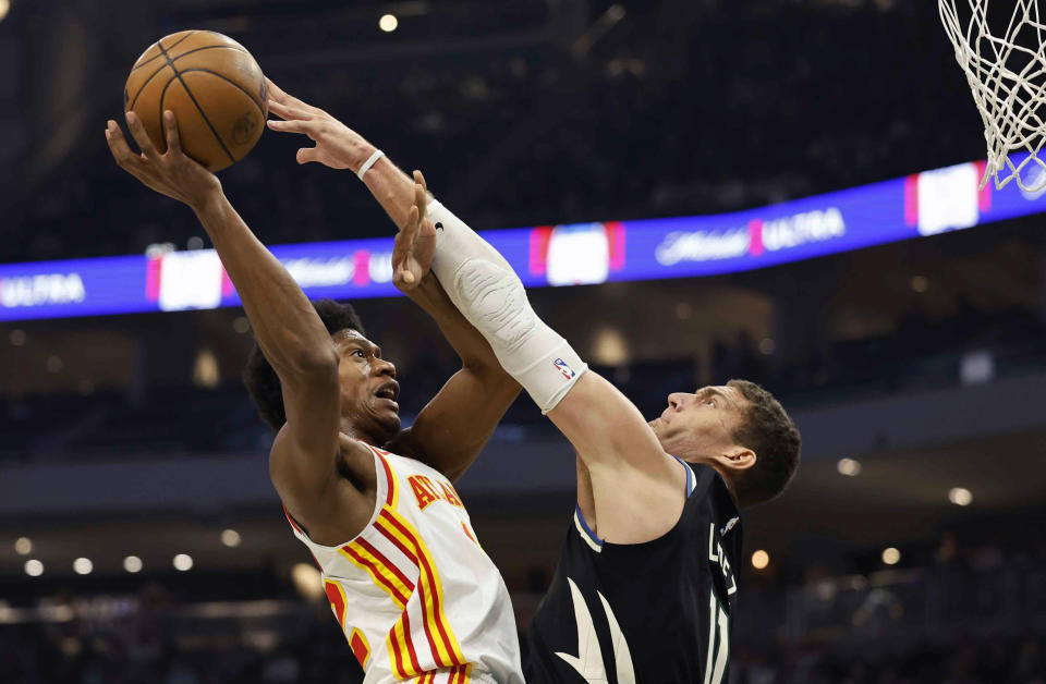 Atlanta Hawks forward Tyrese Martin (22) shoots against Milwaukee Bucks' Brook Lopez (11) during the first half of an NBA basketball game, Saturday, Oct. 29, 2022, in Milwaukee. (AP Photo/Jeffrey Phelps)