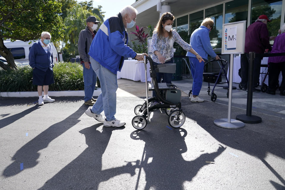 FILE - In this Jan. 19, 2021, file photo, Robert Owens, 90, stands in line with other residents to receive the Pfizer-BioNTech COVID-19 vaccine at John Knox Village in Pompano Beach, Fla. Florida Gov. Ron DeSantis is walking back his claims Friday, Jan. 22, that his state has now vaccinated 1 million seniors. State officials acknowledged that it could take a few more days to reach the milestone. (AP Photo/Lynne Sladky, File)