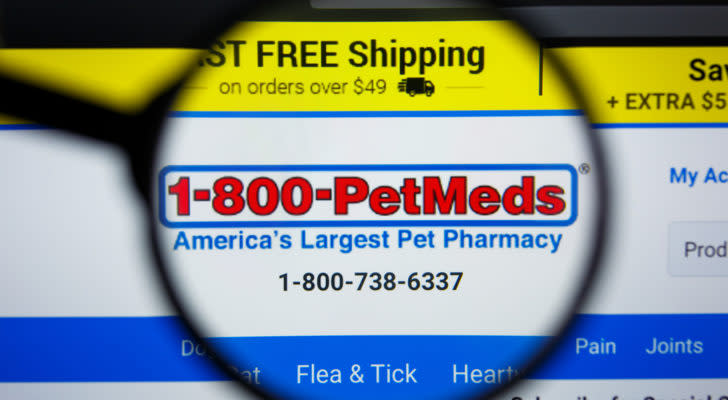 pets stock: petmeds express company logo on a screen, viewed through a magnifying glass