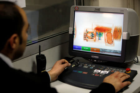 FILE PHOTO - A security official looks at a screen displaying X-ray screened parcels in Turkish Post's (PTT) postal logistic centre at the Ataturk International airport in Istanbul, Turkey on November 6, 2010. REUTERS/Murad Sezer/File Photo
