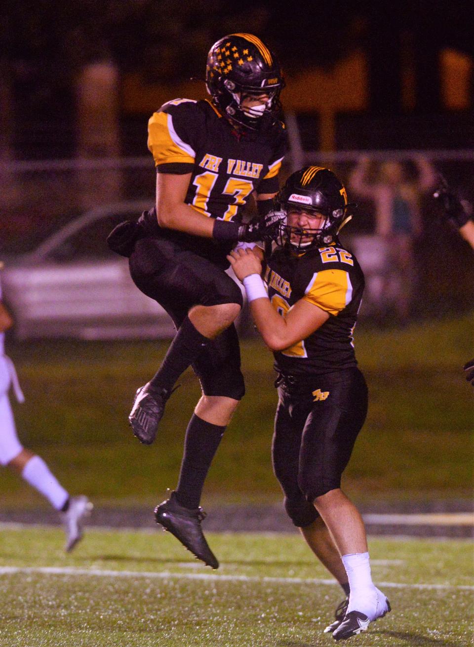 Freshman Max Lyall, left, and junior Hansel Holmes celebrate a defensive stand in the fourth quarter of a 20-7 win against John Glenn during a Week 10 game on Oct. 22, 2021, at Jack Anderson Stadium in Dresden. Lyall and Holmes are among the team's top returners in 2022.