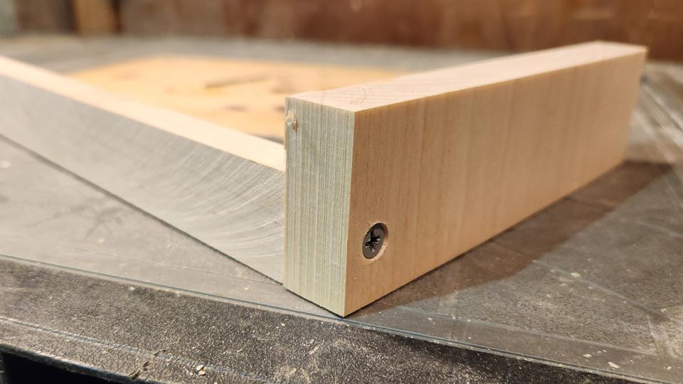 Two wooden boards with a screw