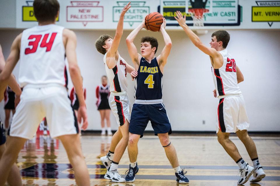 Delta's Neil Marshall navigates a double-team against Wapahani during their championship game at Delta High School Saturday, Jan. 15, 2022.