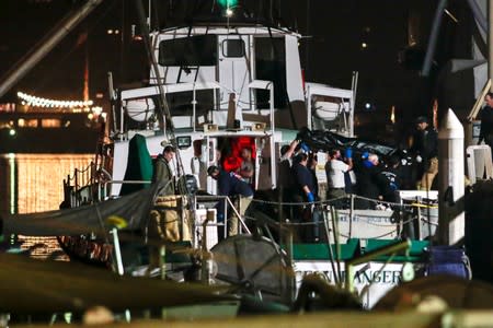 Rescue personnel return to shore with the victims of a pre-dawn fire that sank a commercial diving boat off the coast of Santa Barbara, California