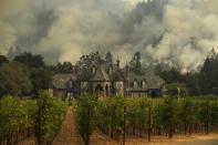 <p>A wildfire burns behind a winery Saturday, Oct. 14, 2017, in Santa Rosa, Calif. Fire crews made progress this week in their efforts to contain the massive wildfires in California wine country, but officials say strong winds are putting their work to the test. (Photo: Jae C. Hong/AP) </p>