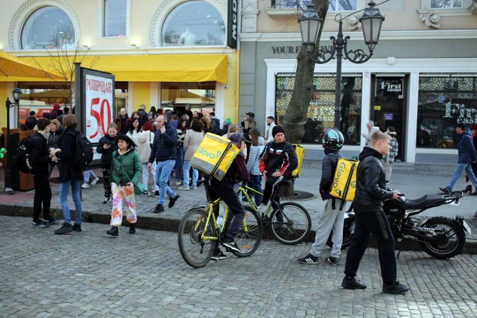 Delivery couriers wait for orders near a McDonald’s, an AmCham member, in Odesa, Ukraine on April 1, 2023. (Viacheslav Onyshchenko/Global Images Ukraine via Getty Images)