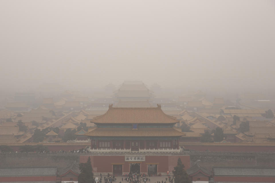In this Jan. 18, 2020 photo, tourists visit the Forbidden City in Beijing. A virus that has killed more than two dozen people and sickened hundreds more has all but shut down China's biggest holiday of the year, the Lunar New Year. Instead of family reunions or sightseeing trips, many of the country's 1.4-billion people are hunkering down as the country scrambles to prevent the illness from spreading further. (AP Photo/Mark Schiefelbein) (AP Photo/Mark Schiefelbein)