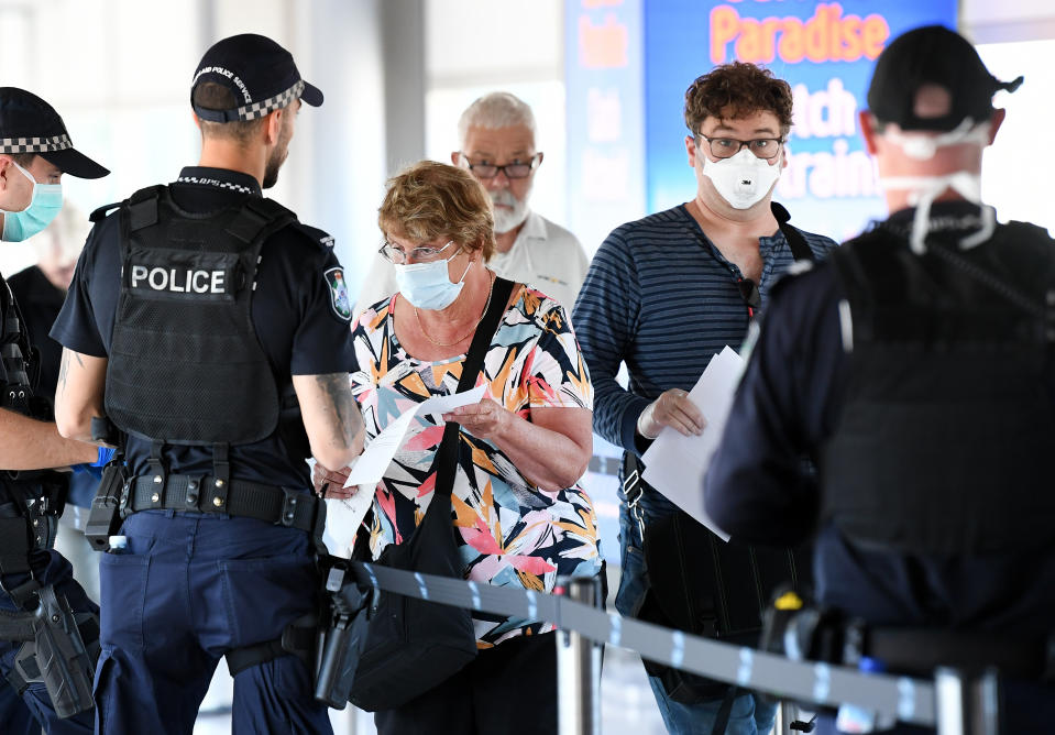 Picture of police screening incoming passengers at the domestic airport in Brisbane, Queensland is one of the Australian states which has closed its borders, limiting interstate travel amid the COVID-19 outbreak