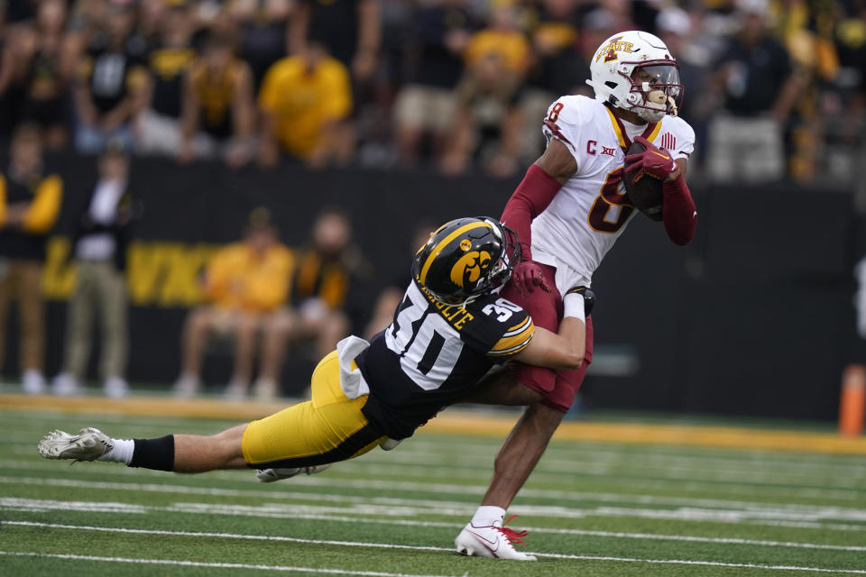 Iowa State wide receiver Xavier Hutchinson (8) is tackled by Iowa defensive back Quinn Schulte (30) after catching a pass during the first half of an NCAA college football game, Saturday, Sept. 10, 2022, in Iowa City, Iowa. (AP Photo/Charlie Neibergall)
