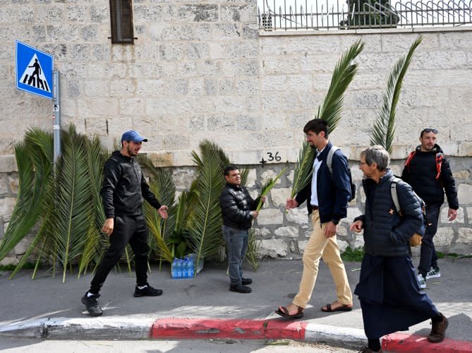 Christians walk in Palm Sunday procession in Jerusalem