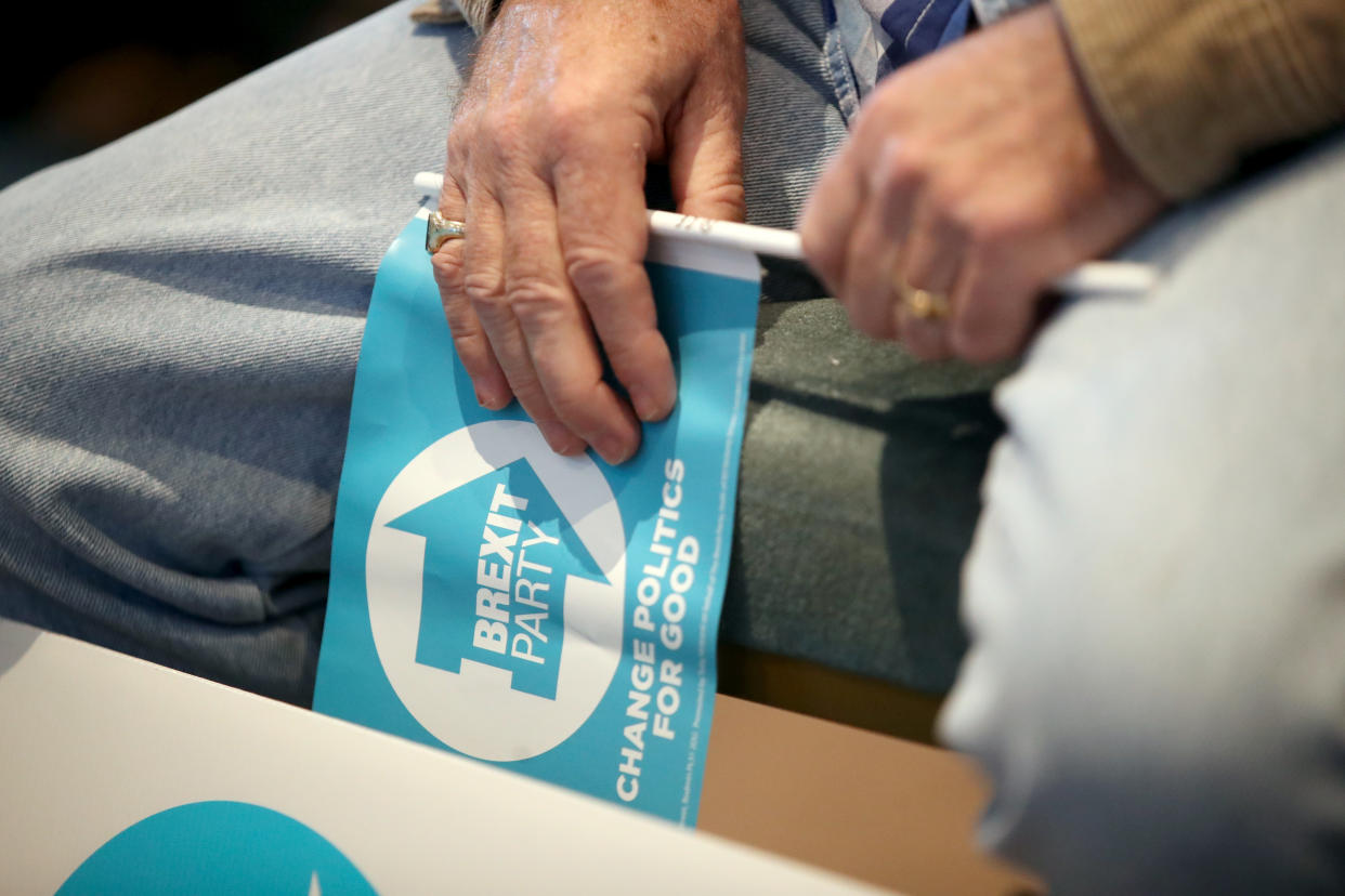 A Brexit Party supporter waits for party leader Nigel Farage to speak at the Washington Central Hotel in Workington.