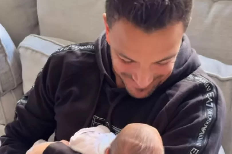 Peter Andre with his newborn daughter