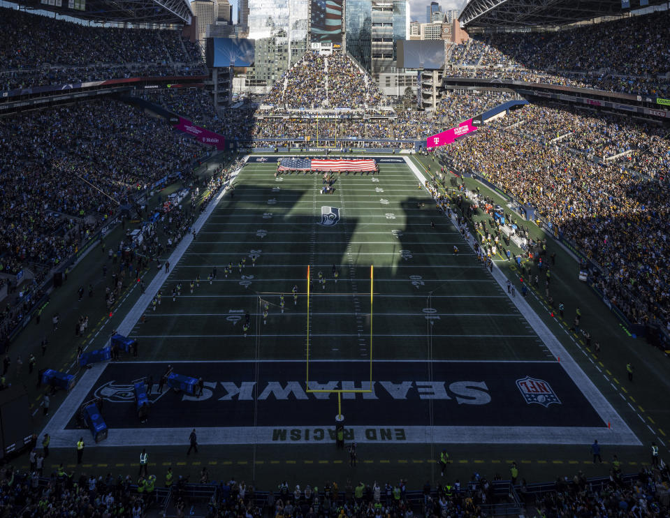 The Seattle Seahawks stadium Lumen Field is viewed during the national anthem before an NFL football game against the Pittsburgh Steelers, Dec. 31, 2023, in Seattle. The head of the Seattle local organizing committee for the 2026 World Cup says the process of eventually putting down a grass surface at Lumen Field is already underway. (AP Photo/Ben VanHouten, File)