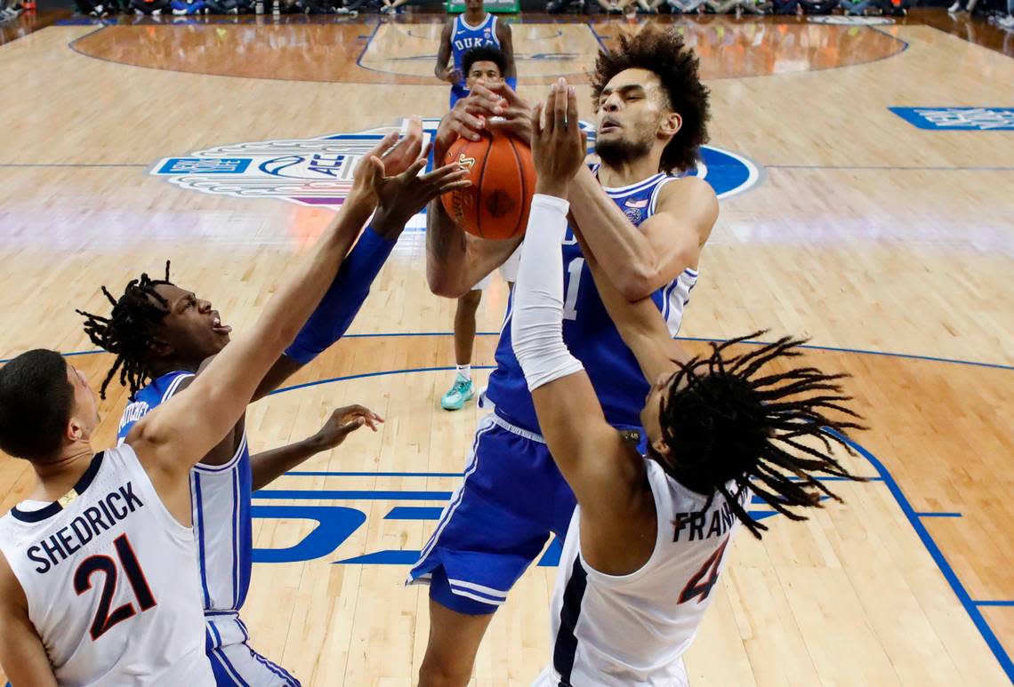 Duke’s Dereck Lively II (1) pulls in a rebound from Virginia’s Armaan Franklin (4) during Duke’s 59-49 victory over Virginia to win the ACC Men’s Basketball Tournament in Greensboro, N.C., Saturday, March 11, 2023.